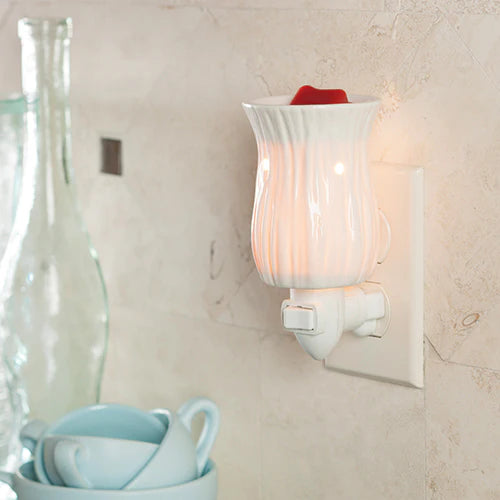 White night light fixture on a wall with a blurred background