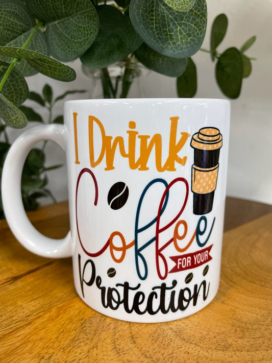 I DRINK COFFEE FOR YOUR PROTECTION COFFEE MUG